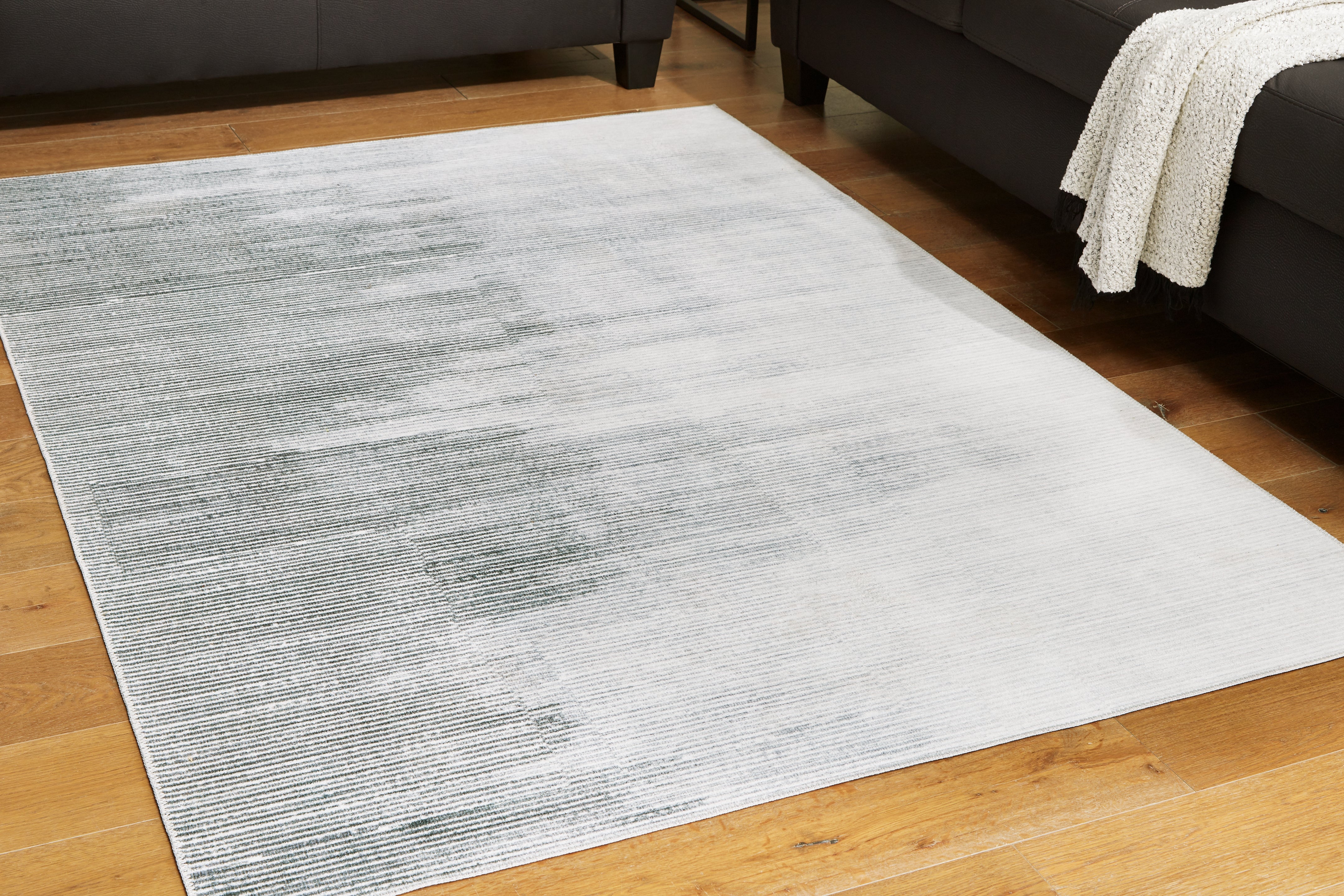 Lullora Furniture - Ashley Furniture - Milset Rug - 8'1" x 10' Washable Rug / Black/White/Gray - R406251