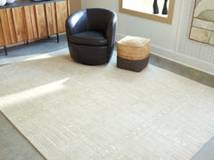 Lullora Furniture - Ashley Furniture - Wolbert Rug - 5' x 7' Area Rug / Tan/Ivory - R407662